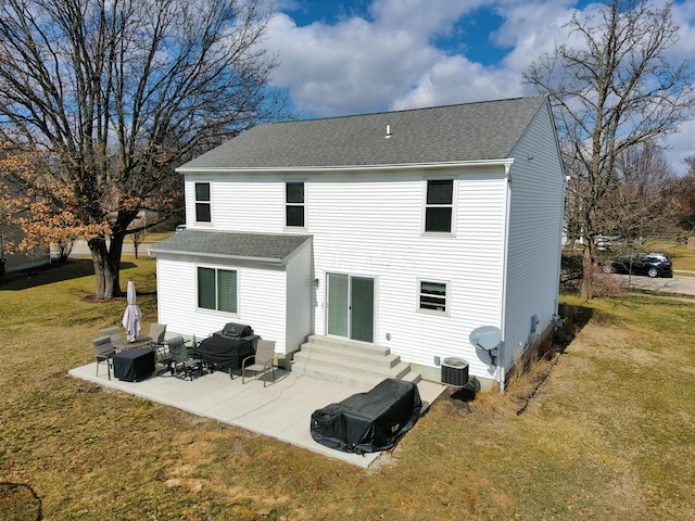 rear view of house featuring entry steps, a patio area, a yard, and roof with shingles