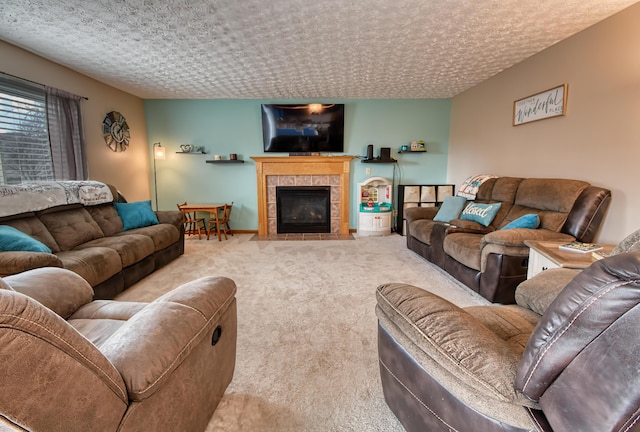 carpeted living room featuring a fireplace and a textured ceiling