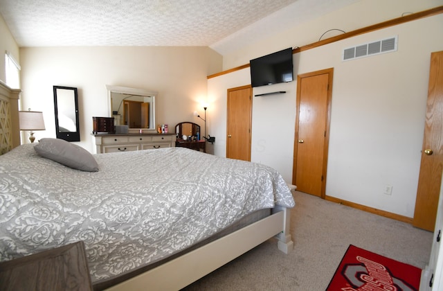 bedroom with carpet, lofted ceiling, visible vents, a textured ceiling, and baseboards