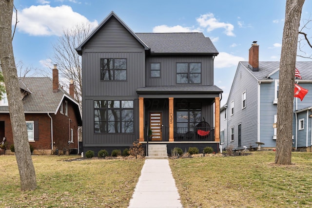 modern inspired farmhouse featuring board and batten siding, a front yard, covered porch, and roof with shingles