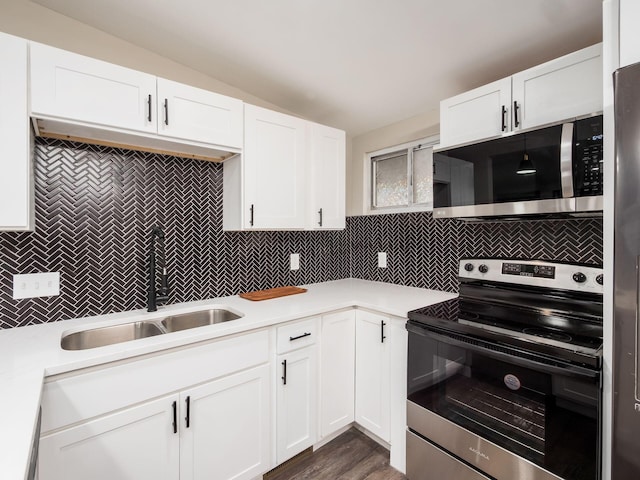 kitchen featuring stainless steel appliances, a sink, light countertops, and decorative backsplash