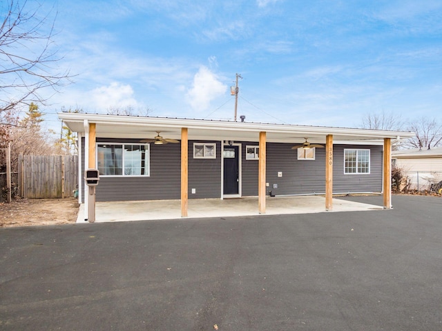 view of front of property with fence and ceiling fan