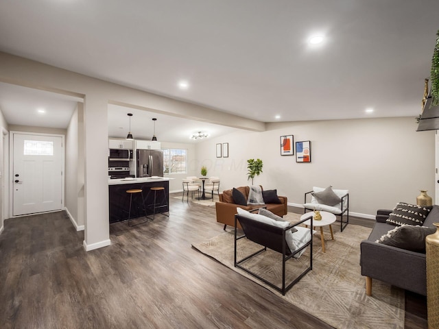 living room with baseboards, dark wood-type flooring, and recessed lighting