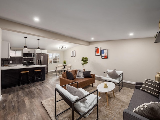 living room with dark wood-style floors, recessed lighting, and baseboards