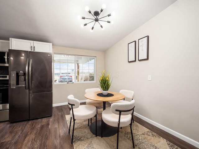 dining room with lofted ceiling, baseboards, a chandelier, and dark wood-style flooring