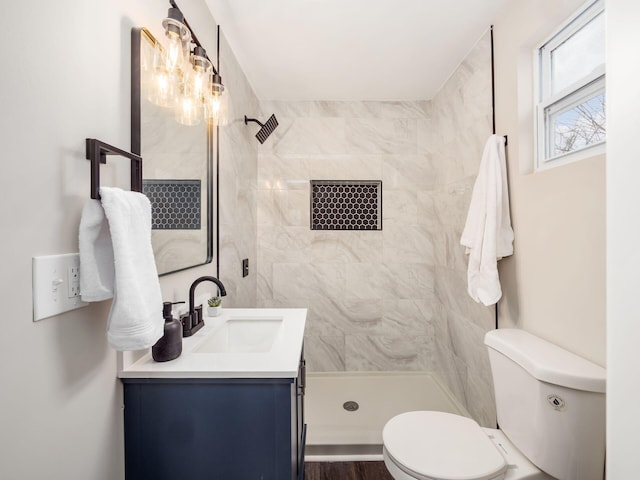 full bathroom with a stall shower, vanity, and toilet