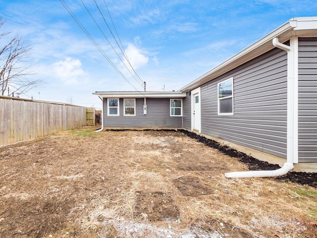 back of house with fence