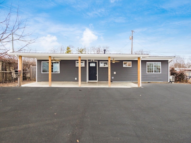 exterior space with metal roof, central AC unit, and fence