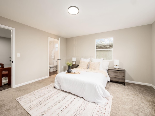 bedroom featuring carpet, connected bathroom, and baseboards