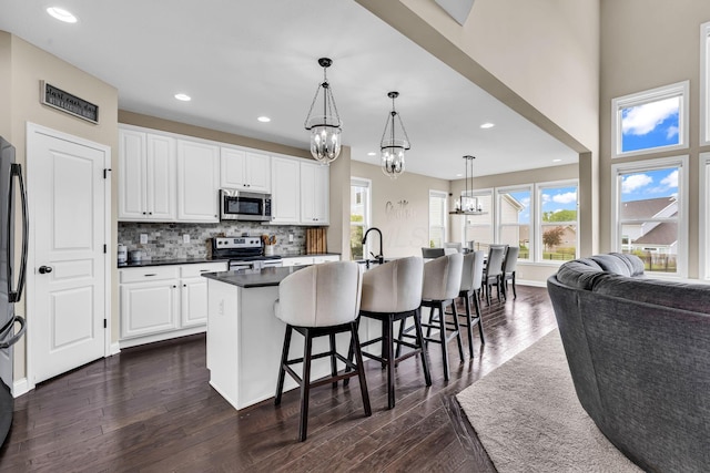 7179 Seymour Ct, Canal Winchester, OH 43110 - kitchen featuring stainless steel appliances, a chandelier, dark countertops, dark wood finished floors, and recessed lighting