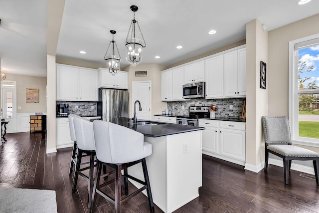 7179 Seymour Ct, Canal Winchester, OH 43110 - kitchen featuring stainless steel appliances, dark countertops, a chandelier, tasteful backsplash, and recessed lighting