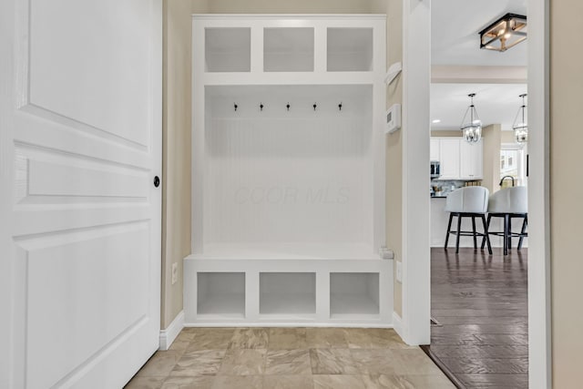 7179 Seymour Ct, Canal Winchester, OH 43110 - mudroom with baseboards and a chandelier