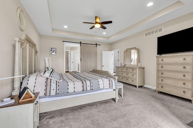 7179 Seymour Ct, Canal Winchester, OH 43110 - carpeted bedroom with a tray ceiling, a barn door, recessed lighting, and ceiling fan