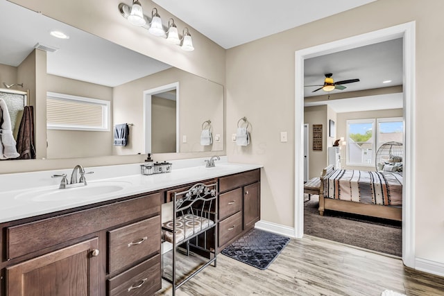 7179 Seymour Ct, Canal Winchester, OH 43110 - full bathroom featuring double vanity, wood finished floors, ceiling fan, ensuite bath, and a shower with shower door