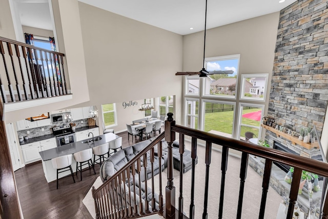 7179 Seymour Ct, Canal Winchester, OH 43110 - stairway featuring a towering ceiling, wood finished floors, healthy amount of natural light, a stone fireplace, and recessed lighting