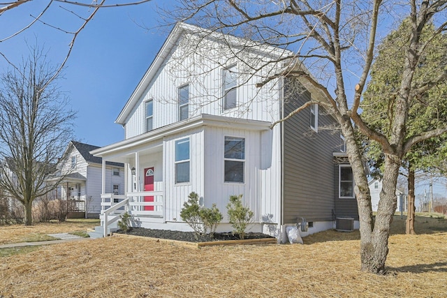 view of front of house with a porch, cooling unit, and board and batten siding