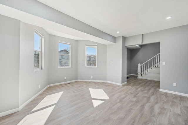 interior space with stairway, recessed lighting, light wood-type flooring, and baseboards