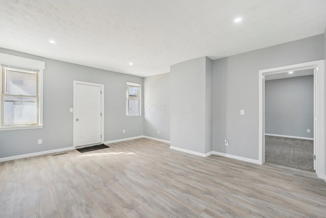 interior space with recessed lighting, light wood-style flooring, and baseboards