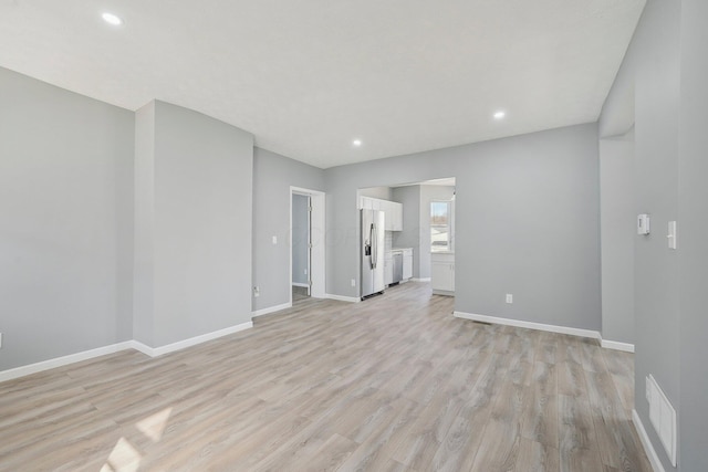 unfurnished living room with light wood finished floors, visible vents, recessed lighting, and baseboards