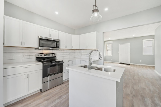 kitchen with a sink, light countertops, backsplash, and stainless steel appliances