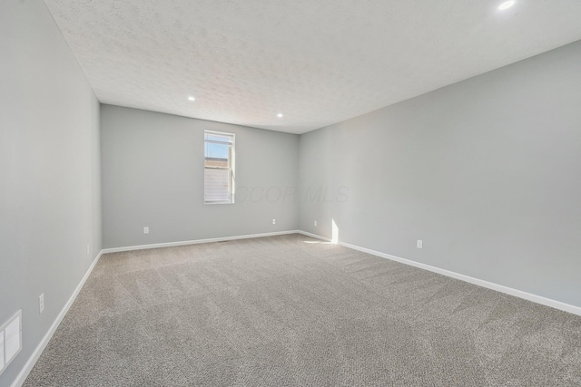 carpeted empty room featuring recessed lighting, baseboards, and a textured ceiling