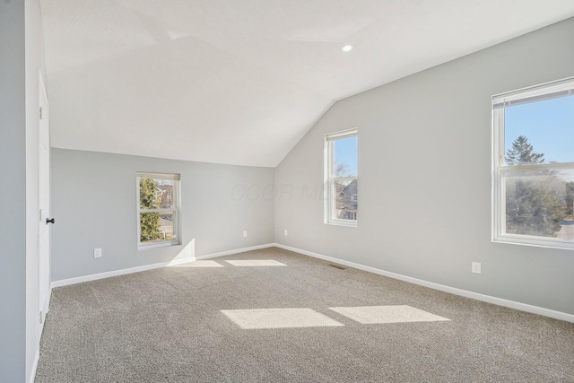 bonus room with carpet flooring, visible vents, baseboards, and vaulted ceiling