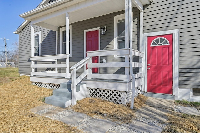 view of exterior entry featuring covered porch