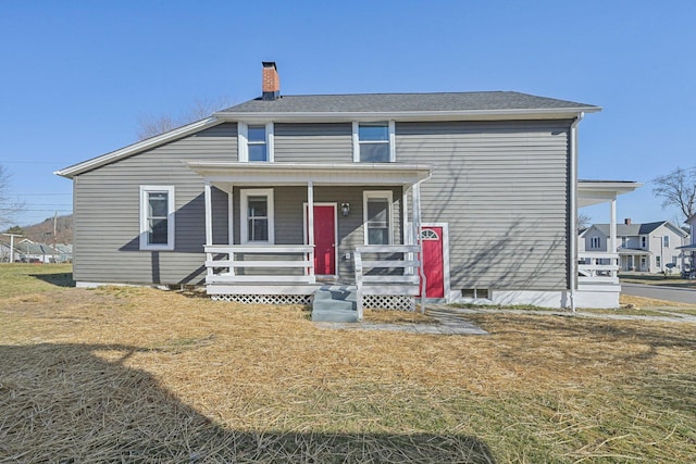 view of front of home featuring covered porch and a chimney