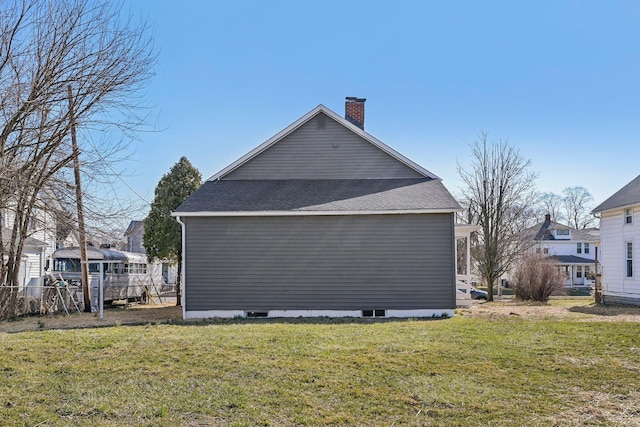 view of home's exterior with a yard and a chimney