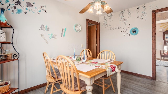 dining room with baseboards, a ceiling fan, and wood finished floors