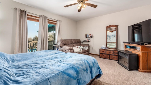 bedroom featuring light colored carpet, baseboards, and ceiling fan