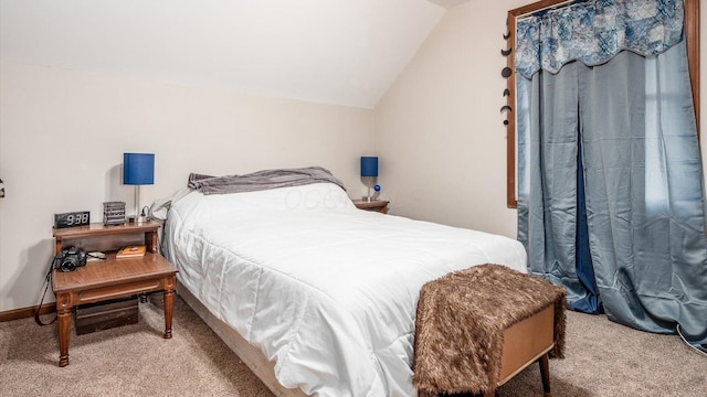 carpeted bedroom featuring baseboards and lofted ceiling