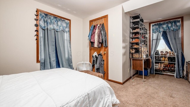 bedroom featuring baseboards and carpet flooring