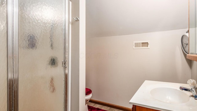 full bathroom with vanity, baseboards, visible vents, a stall shower, and toilet