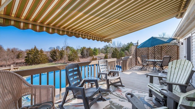 wooden terrace featuring outdoor dining area