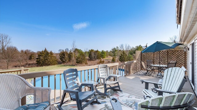 wooden deck featuring outdoor dining area