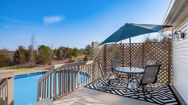 wooden terrace featuring an outdoor pool