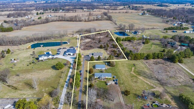 birds eye view of property featuring a rural view