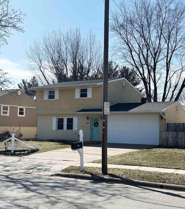 view of front facade featuring an attached garage, fence, and concrete driveway