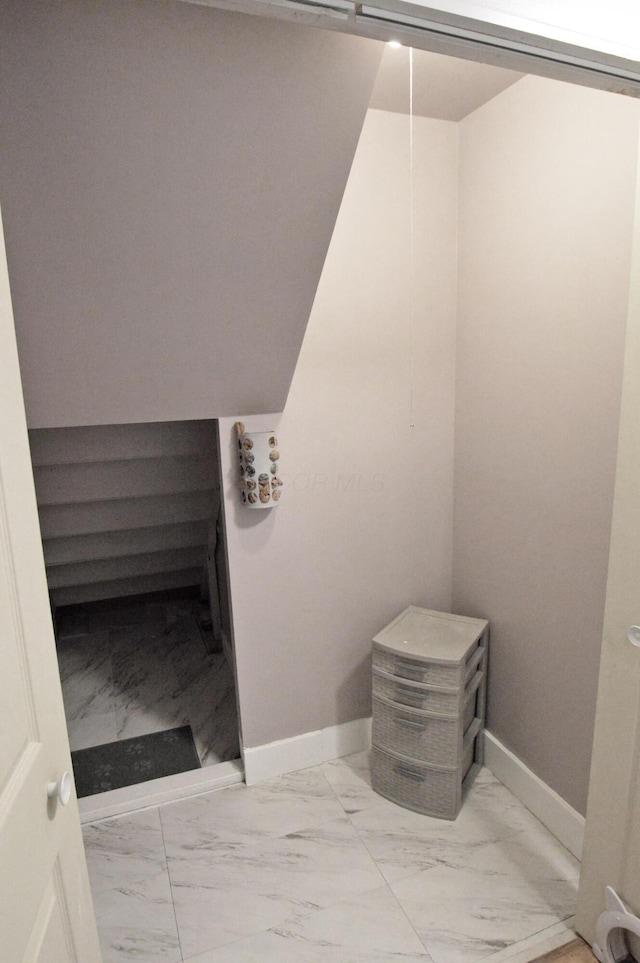 bathroom with marble finish floor and baseboards