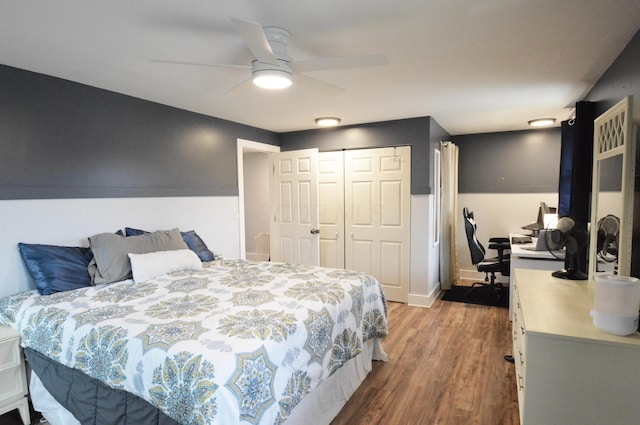 bedroom featuring a ceiling fan, a closet, baseboards, and wood finished floors