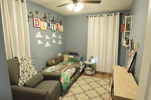 bedroom featuring a ceiling fan and wood finished floors