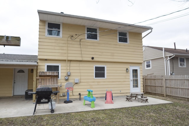 rear view of house with a patio and fence