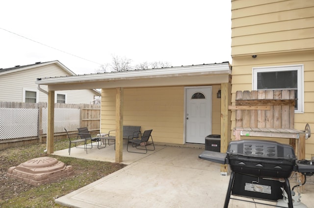 view of patio / terrace with area for grilling and fence