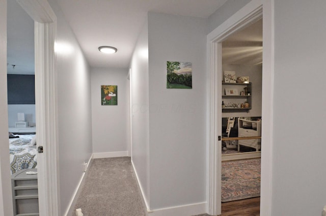 corridor with carpet flooring and baseboards