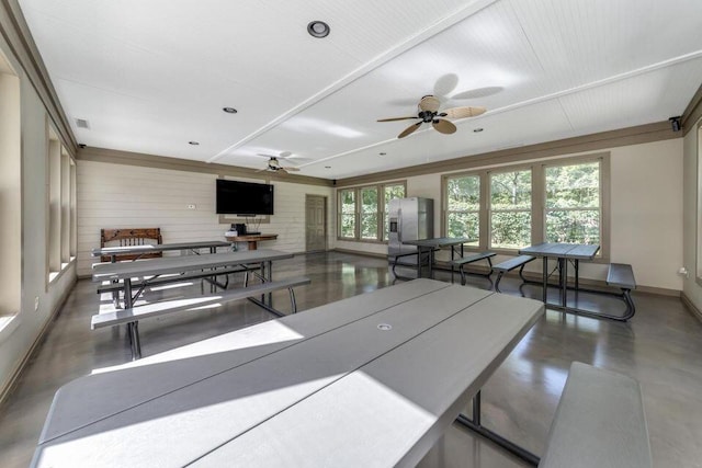 interior space featuring baseboards, concrete flooring, and ceiling fan