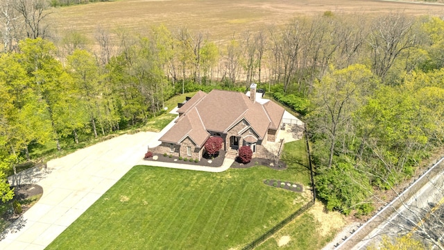 birds eye view of property with a forest view