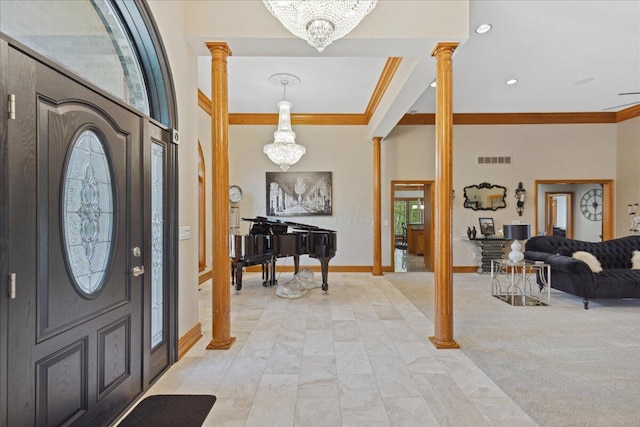 entryway with ornate columns, baseboards, visible vents, a notable chandelier, and crown molding