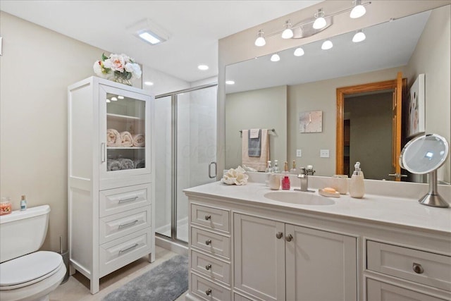 bathroom featuring vanity, toilet, recessed lighting, and a shower stall