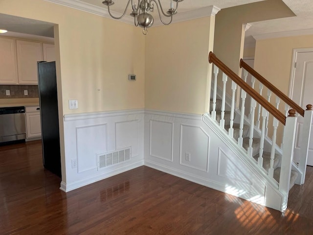 interior space with dark wood-style floors, visible vents, ornamental molding, and stairs